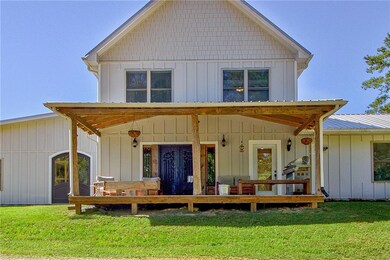 Rear view of house featuring a lawn