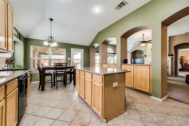 Open kitchen with extra cabinets in separation wal