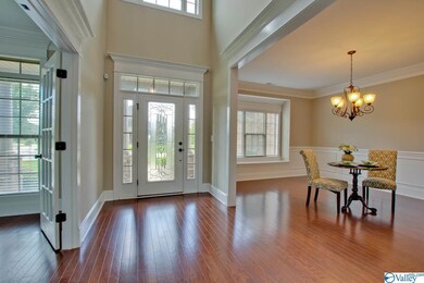 greets you as you take in all the splendor this home has to offer. The stunning hardwood floors and extensive trim details play wonderfully together.