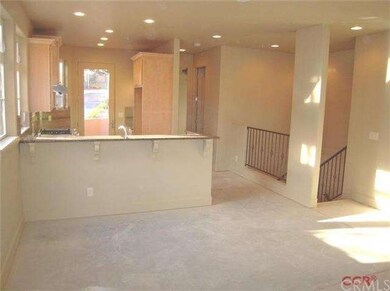 View showing the kitchen bar and open floor plan. 