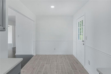 dining area with light wood-style floors, baseboar