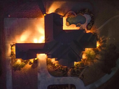 Enhance the allure of this extraordinary property with captivating uplighting that transforms it into a breathtaking spectacle after the sun sets.