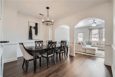 Dining room featuring crown molding, dark wood-sty