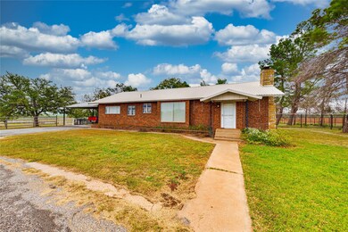 Ranch-style home featuring brick siding, a front l