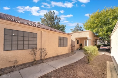 View of home's exterior with stucco siding and a tile roof