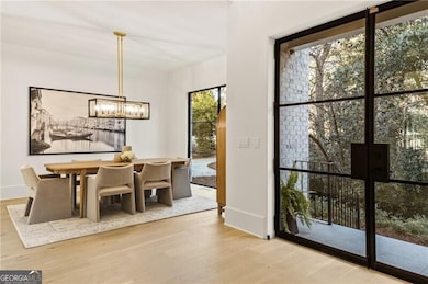 Separate dining room with views to the lush front yard connects directly to the Butler's pantry/wet bar.