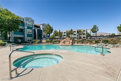 Community pool featuring a community hot tub, a pa
