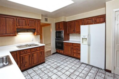 Eat-in Kitchen with lots of wood cabinetry, cerami