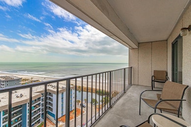 Balcony featuring a water view and a view of the beach