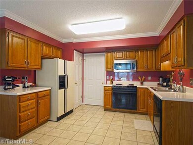 Kitchen. Kitchen is open with a pantry and breakfast eating area.  Door leads back into Dining room.