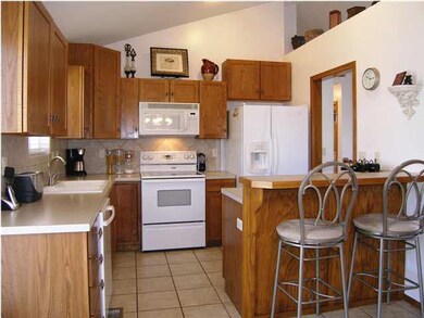 A VIEW OF THE KITCHEN WITH SHAKER CABINETRY AS SEE