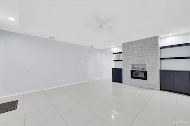 Unfurnished living room with ceiling fan, arched walkways, built in shelves, recessed lighting, and light tile patterned floors