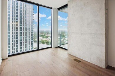 Empty room with floor to ceiling windows, a city