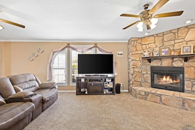 Carpeted living room featuring crown molding, base