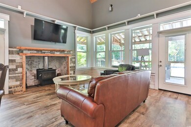 Living room with a wood stove, hardwood / wood-sty