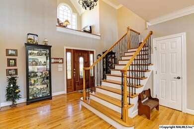 Walk in the front door to find sweeping views of the living area.  One of the many features of this home is it's beautiful stair case with wrought iron and wood railings.