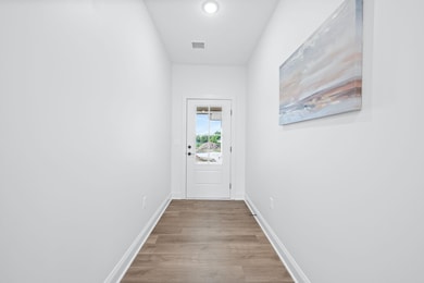 Entryway with wood finished floors and baseboards
