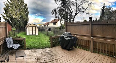 This fully fenced in back yard features a new shed