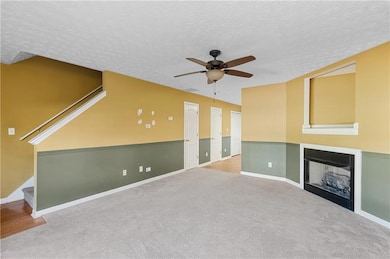 Unfurnished living room featuring light carpet, a 