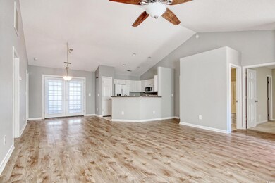 Unfurnished living room with ceiling fan, high vau