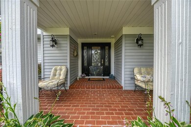 A covered brick entry way is large enough for seat