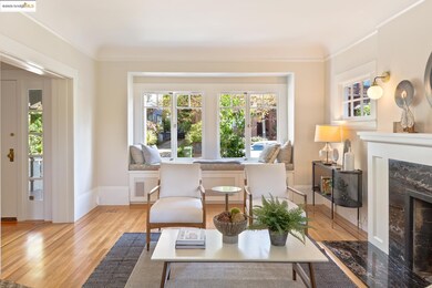 Sitting room with a fireplace, wood finished floors, and ornamental molding