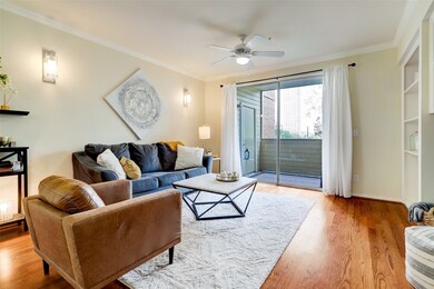 Living room looks over the sunset balcony which  provides a plethora of sunshine into this well kept condo.