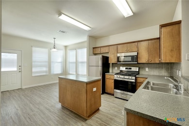 Large kitchen with island, gas range & refrigerator