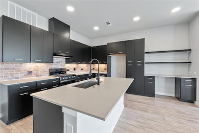Kitchen featuring stainless steel range with gas 