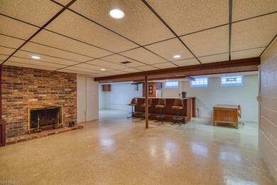 Open family room and rec room with a brick firepla