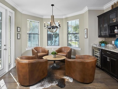 Living area with bar, dark hardwood / wood-style f