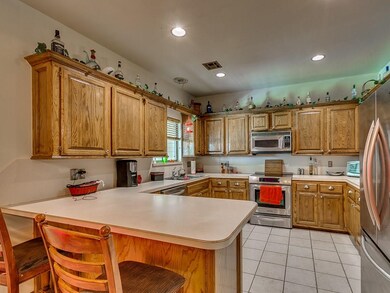 Another view of the kitchen and the breakfast bar.