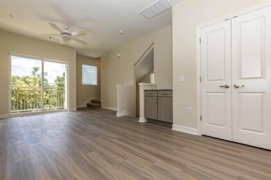 Unfurnished living room with visible vents, wood 