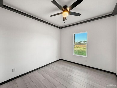 Spare room featuring ceiling fan, light hardwood / wood-style flooring, and ornamental molding