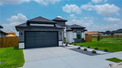 Prairie-style home with concrete driveway, stone siding, a garage, and a shingled roof