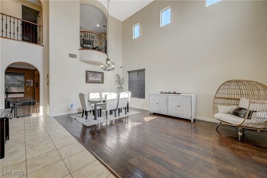 Dining space featuring arched walkways, a high cei