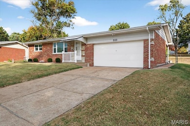 Single story home featuring a front lawn, brick siding, concrete driveway, and an attached garage