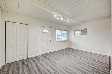 Entryway with baseboards, wood finished floors, wo