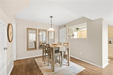 Dining area with baseboards, wood finished floors,