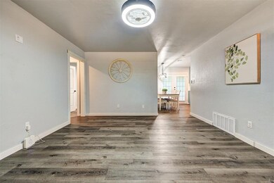 Living room with laminate flooring, all new paint,