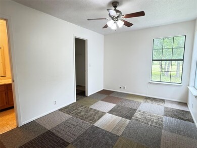 Spare room with carpet flooring, a ceiling fan, a