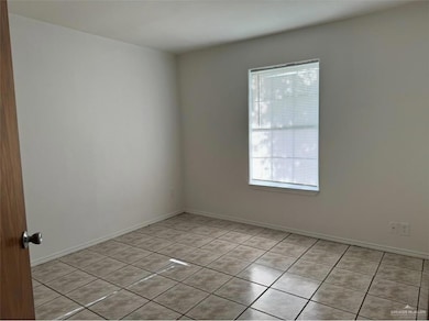 Unfurnished room featuring light tile patterned floors