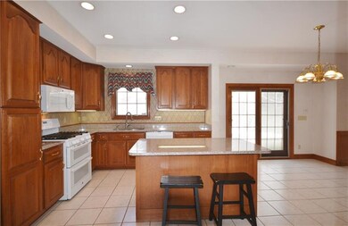Kitchen features recessed lighting, sliding door t