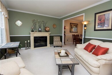 Your two-toned formal living room is well decorated with chair rail and crown moldings!