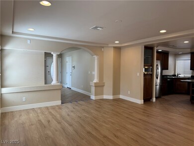 Unfurnished living room featuring ornate columns,