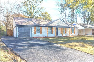 Ranch-style house featuring a porch, a garage, and