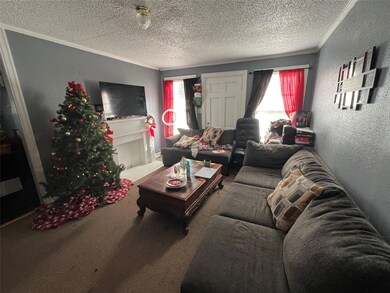 Carpeted living room with a healthy amount of sunl