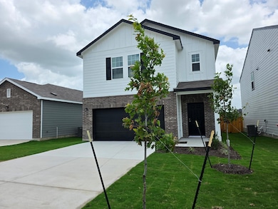 View of front of home with brick siding, board an