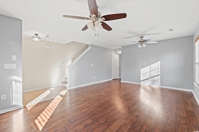 Unfurnished living room with ceiling fan and light