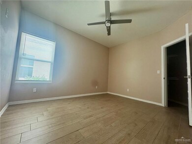 Unfurnished bedroom with baseboards, a ceiling fan, and wood finished floors